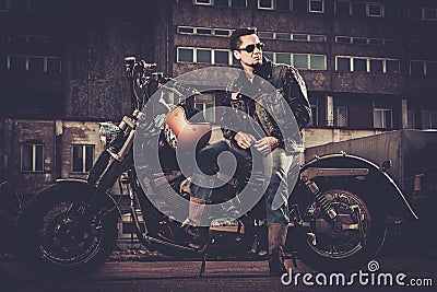 Biker and his bobber style motorcycle Stock Photo
