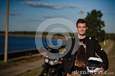 Biker holding his helmet Stock Photo