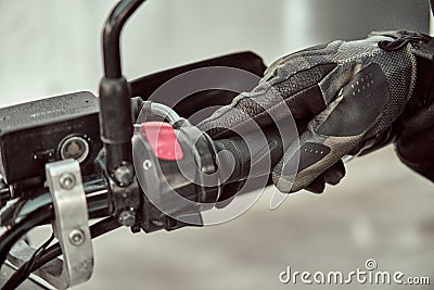 Biker holds onto throttle handle of a motorcycle. Close up shot Stock Photo