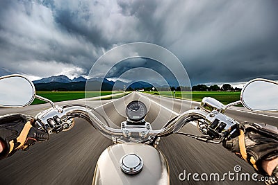 Biker on a motorcycle hurtling down the road in a lightning storm - Forggensee and Schwangau, Germany Bavaria Stock Photo