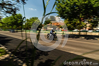 Biker on a motorcycle in traffic at rush hour in downtown area of the city in Bucharest, Romania, 2022 Editorial Stock Photo