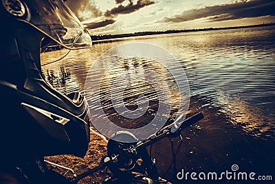 biker motorcyclist helmet hat rudder lake Stock Photo