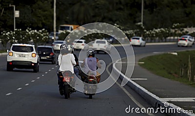 Biker pushes colleague with foot Editorial Stock Photo