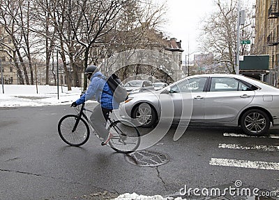 Biker rides along Bronx community in winter snow season Editorial Stock Photo