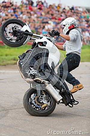 Biker rides on the rear wheel Editorial Stock Photo