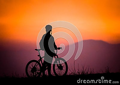 biker silhouette watching the sunset Stock Photo