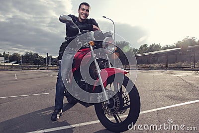 Biker sitting on sporty motorcycle Stock Photo