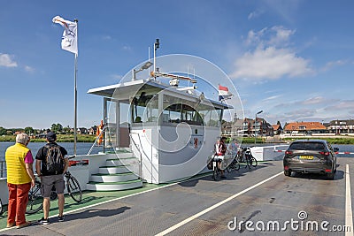 Bikers and car at ferry crossing Dutch river Meuse Editorial Stock Photo