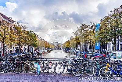 Bikes chained to the railing a bridge on the Leidsestraat over the Keizersgracht is typical for a bike city like Amsterdam Editorial Stock Photo