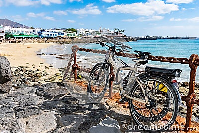 Bikes or Cycles at seaside promenade in Playa Blanca, the former fishermens village became a main touristic spot with opening of Editorial Stock Photo