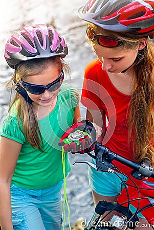 Bikes cycling children girl wearing helmet look at compass. Stock Photo