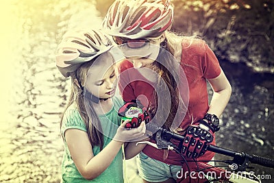 Bikes cycling children girl wearing helmet look at compass. Stock Photo