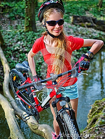 Bikes cycling girl cycling fording throught water . Stock Photo