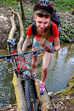 Bikes cycling girl cycling fording throught water. Stock Photo