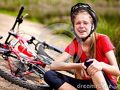 Bikes cycling girl wearing helmet. Girl girl fell off bike. Stock Photo