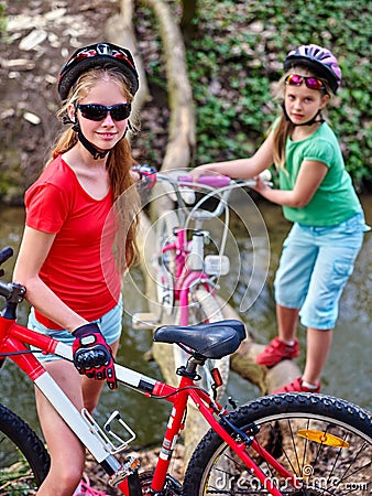 Bikes girl cycling fording throught water . Stock Photo