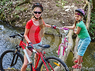 Bikes girl cycling fording throught water . Stock Photo