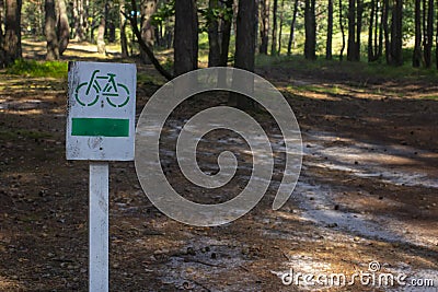 Bikeway in the forest. Wooden road sign Stock Photo