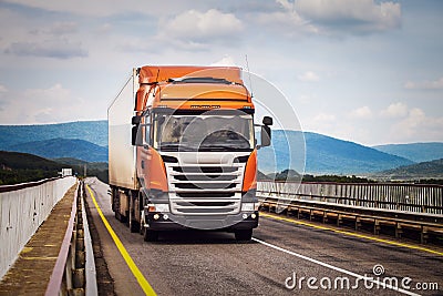 Orange truck on a road Stock Photo