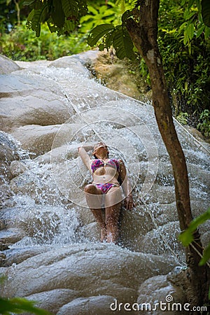 Bikini Girl enjoys refreshing water of sticky waterfall Bua Tong Waterfalls Chiang Mai Stock Photo