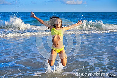 Bikini girl jumping in Caribbean sunset beach Stock Photo