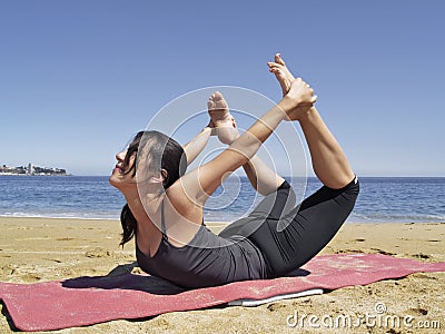 Bikram yoga dhanurasana pose Stock Photo