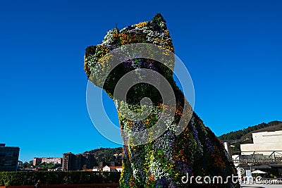 Puppy sculpture covered with flowers by the artist Jeff Koons Editorial Stock Photo