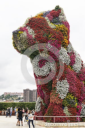 Bilbao, Spain, September 2019: A flower puppy statue in front of Guggenheim Museum in Bilbao, Spain. Editorial Stock Photo