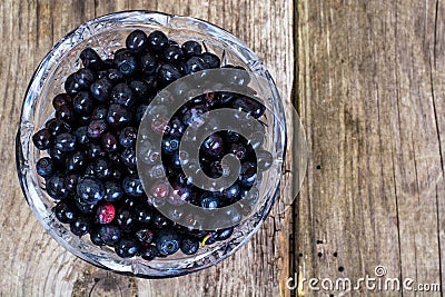 Bilberry in Crystal Bowl on Rustic Background Stock Photo