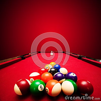 Billards pool game. Color balls in triangle, aiming at cue ball Stock Photo