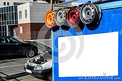 Billboard, small car center, service of cars and repair of disks on the street, wheels, the Stock Photo