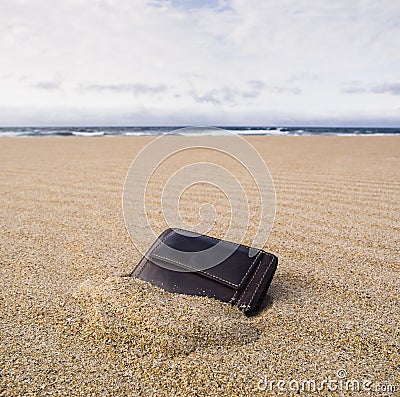 Billfold on the beach over the sand Stock Photo