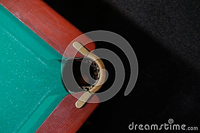 Billiard pocket in a pool table background. Stock Photo