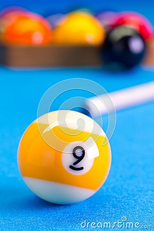 Billiard pool game nine ball with cue on billiard table Stock Photo