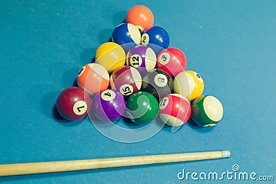 Billiards balls and cue on billiards table Stock Photo