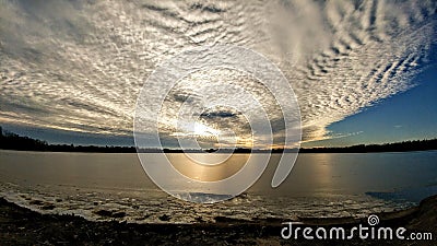 Billowy Clouds over Lake with Golden Light Stock Photo
