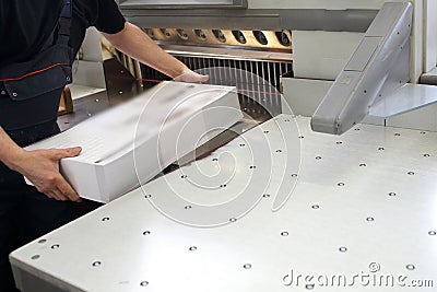 Bindery. Paper trimming on a guillotine Stock Photo