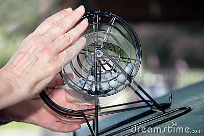 Bingo! A Close-Up of Hands with Bingo Wheel and Balls Stock Photo