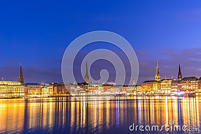 Binnenalster Lake with illuminated city center in Hamburg, Germany during twilight sunset Editorial Stock Photo