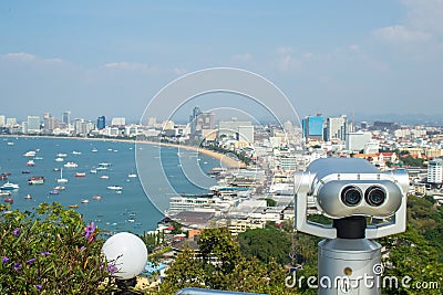 Binocular or telescope locate on viewpoint for support traveler use looking for view of Pattaya city. Stock Photo