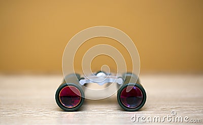 Binoculars, optical device on a wooden tabletop Stock Photo