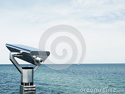 Binoculars on a pier, concept for far-sightedness or look into the future Stock Photo