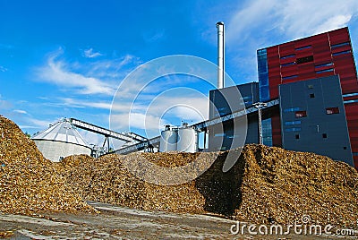 Bio power plant with storage of wooden fuel (biomass) against bl Stock Photo