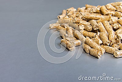 Biofuels. Wood pellets on a silver background.Pellets Biomass - Stock Photo