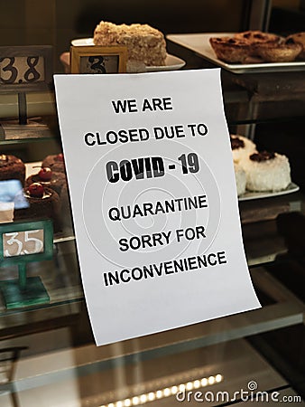 Biohazard concept of living in a new reality of coronavirus epidemic hysteria cafe owner sticks advertisement on quarantine Stock Photo