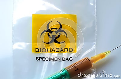 Biohazard specimen bag with a syringe and brown liquid Stock Photo