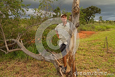 Biologist out in the savannas of Brazil, inspecting a tree Stock Photo