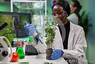 Biologist scientist putting solution from medical flask Stock Photo