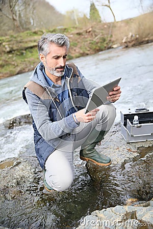 Biologist testing quality of natural water outdoors Stock Photo