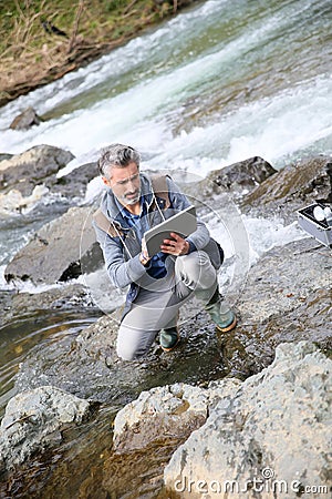 Biologist testing water quality of river Stock Photo